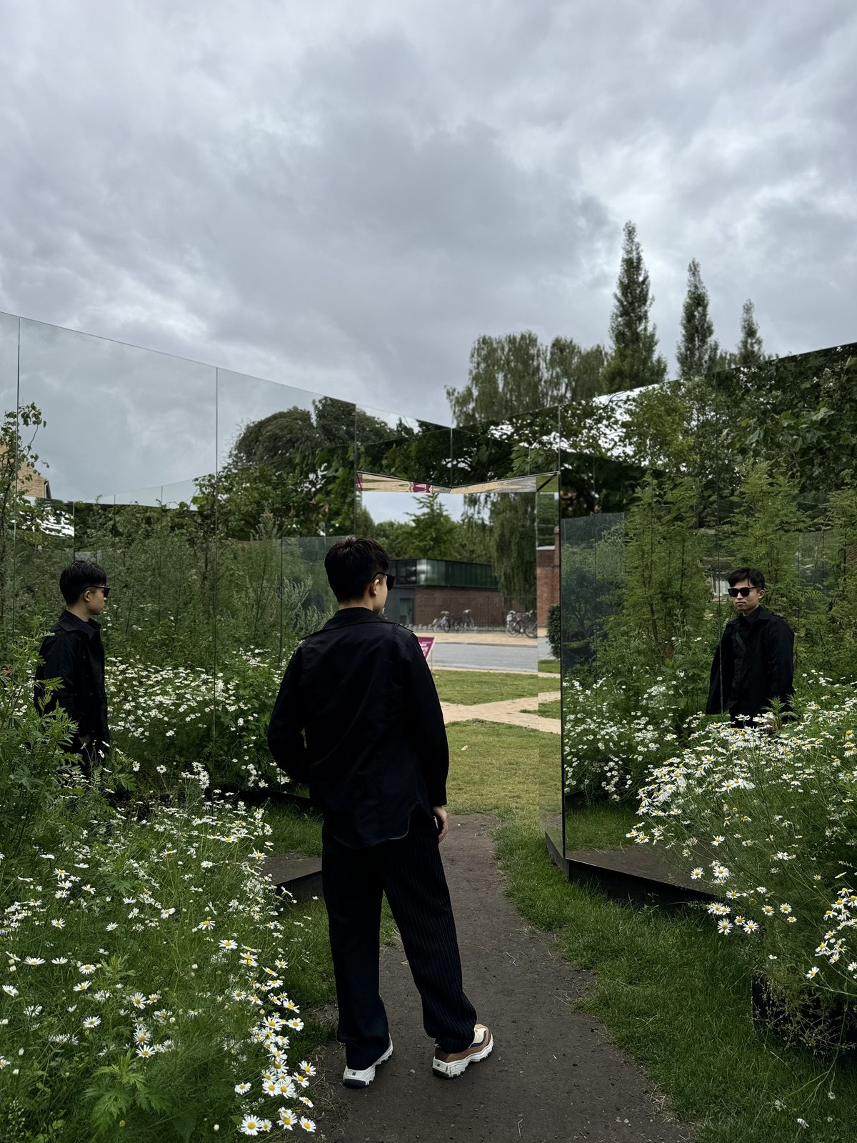 Yu Ma among mirrored panels and daisies